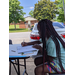 Young female resident with braids drawing on poster 