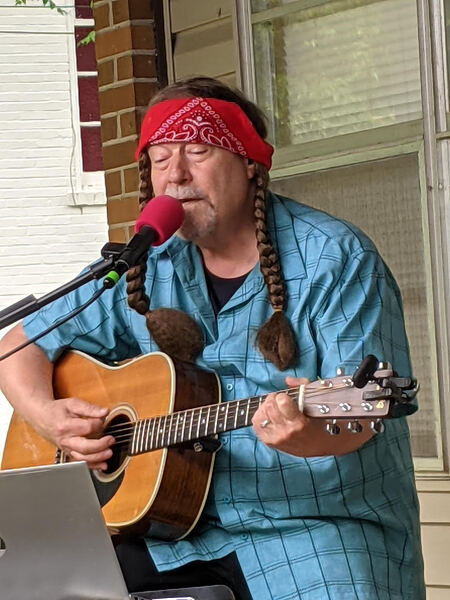 Bill King playing guitar and singing
