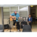 Bill King singing and playing guitar outside