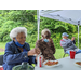 Senior Residents eating outside under tents at Wonderful Wednesday event