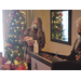 Female employee opening a box gift near Christmas tree