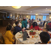 Group of employees talking at luncheon around banquet tables