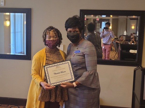 Charlotte Bowen receiving certificate from CEO Sharon Tolbert