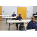 Employees at annual meeting sitting behind individual desks