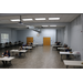 Aerial view of employee meeting at staff sitting behind desks in a spacious room