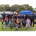 Auburn Police officers helping youth receiving free bikes on bikes