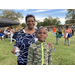 Woman and young boy posing with water in hand for camera