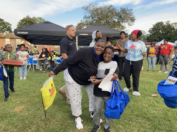 Female hugging young boy with excitement at National Night Out