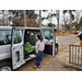 Male leaning on open van door. Inside van there are fresh green vegetables