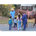 Commissioner and kids brushing horse