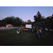 Sparkman community residents gathered on lawn watching outdoor movie 