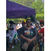 Female Juneteenth attendee standing with arms crossed outside.