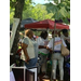 Juneteenth attendees standing and talking under a tent.