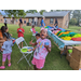 Young girl is showing off her craft with her mouth wide open at the back to school event