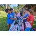 Volunteers are sorting backpacks for giveaway at the back to school event