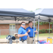 Two Auburn Police officers are giving the thumbs up under tent