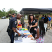 Auburn police officer is talking with a young girl at the supply table.