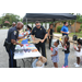 Auburn Police officers are passing out supplies to youth lined up at the table 