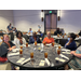 Auburn Housing Authority Staff and Commissioners are sitting at the annual conference banquet at a circular table.