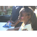 Young girl with braids showing off her cheek heart face painting 