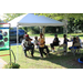 residents sitting under tent at the tailgate event