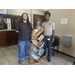 Austin Pearson of LCLC is standing with AHA's AJ Harris and the new pop-up wooden bookshelf library for the Ridgecrest Admin Office. 