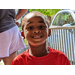 Young boy is up close and smiling at the camera