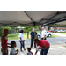 Youth and adults under tent at tailgate event