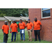 RHA Maintenance staff are outside posing in front of brick building 