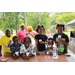 Youth smiling and eating snow cones at the tailgate event