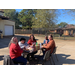 Staff members sitting around table at Iron Bowl tailgate event