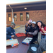 Staff and Board members smiling while sitting at Iron Bowl tailgate event