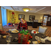 Staff member behind table at Christmas Luncheon