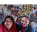 Charlotte Mattox and employee taking selfie in front of Christmas tree
