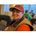 Male in hat smiling at Christmas luncheon