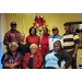 Board members posing together in front of Christmas tree 