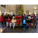 All employees, commissioners, and guest posed in front of Christmas tree 