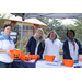 Auburn Housing Authority Staff posing under tent at Operation CommUNITY event with orange pumpkin containers on the table