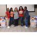 Auburn Staff posing beside Beat Bama Food Drive Donation containers.