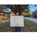 Nylah Dowdell holding her winning poster contest