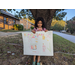 Sydney McPherson holding her winning poster