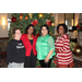 Female staff members posed in front of the Christmas tree
