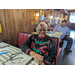 Older lady sitting in booth at restaurant