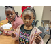Young African American girls showing off their Christmas craft