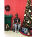 Rodriquez Brewer sitting at community Christmas tree