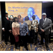 Scholarship Breakfast attendees standing in front of MLK background