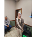 Sandra Sanders standing and smiling with retirement sash 