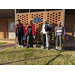 Group of senior citizens standing outside Porter Community Building brick wall in winter attire 