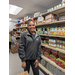 Volunteer inside the Boykin Food Pantry standing near a stocked shelf
