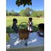Two children behind a table that has a big easter basket on it 